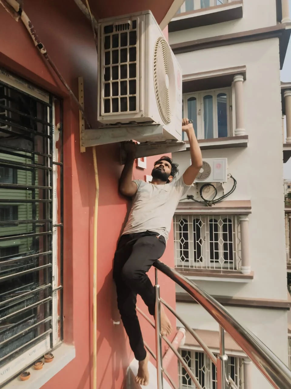 Technician working on outdoor AC unit