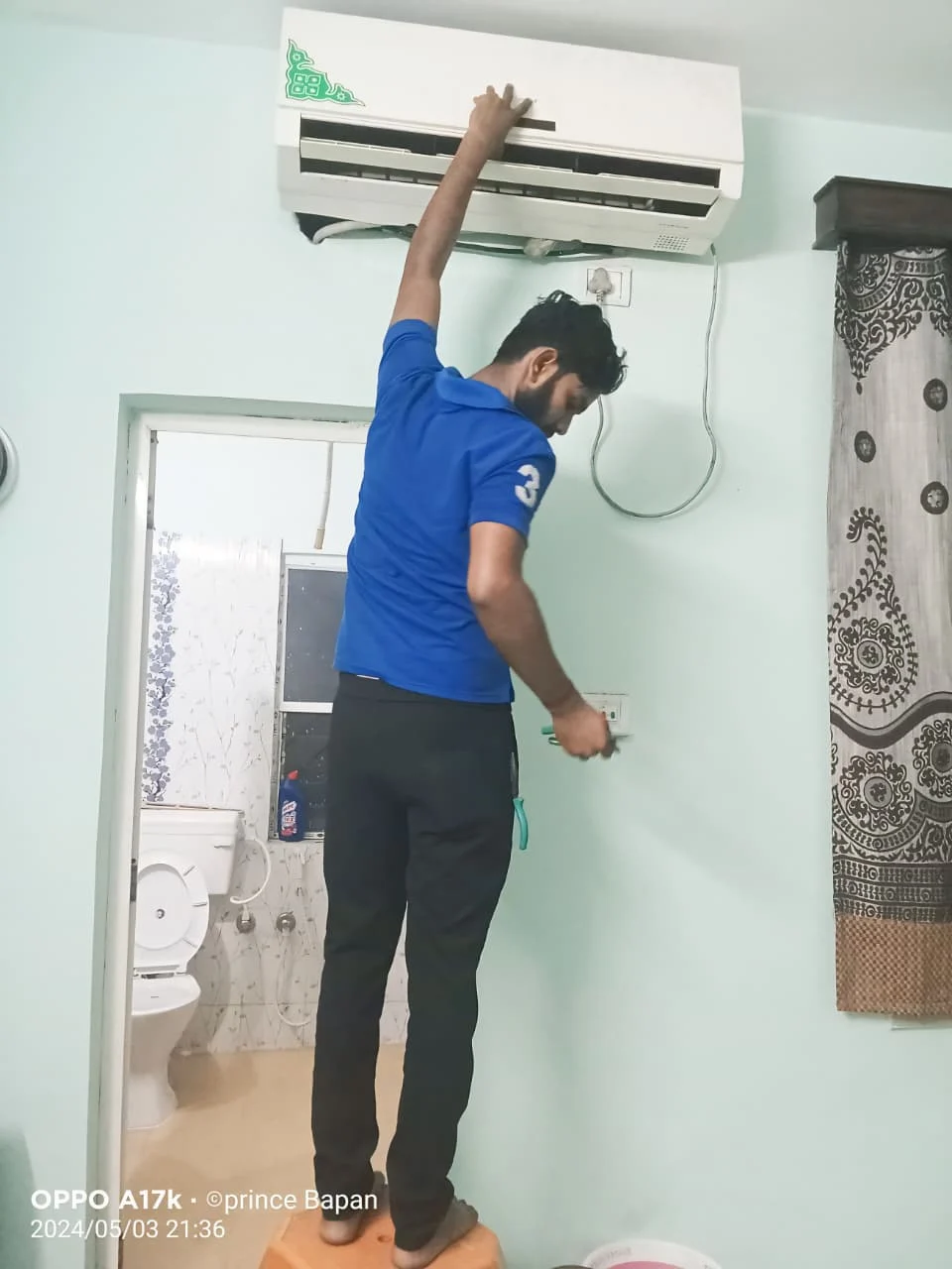 Technician repairing indoor AC unit