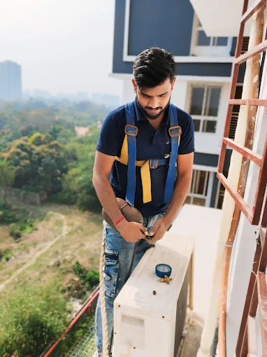 AC gas charging service on a New Town high-rise balcony